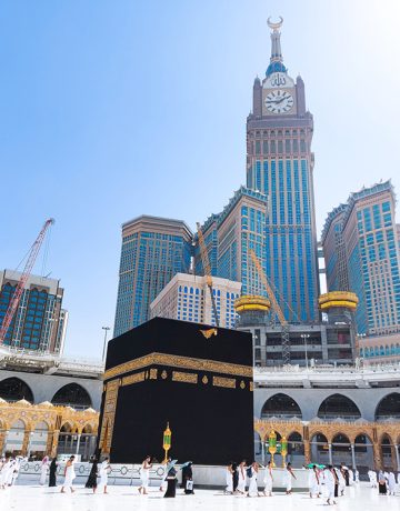 MECCA, SAUDI ARABIA , OCTOBER 22, 2020 - Pilgrims circle the Kaaba at Masjid al-Haram - umrah Fewer Muslims people Socially Distanced corona virus wearing face mask